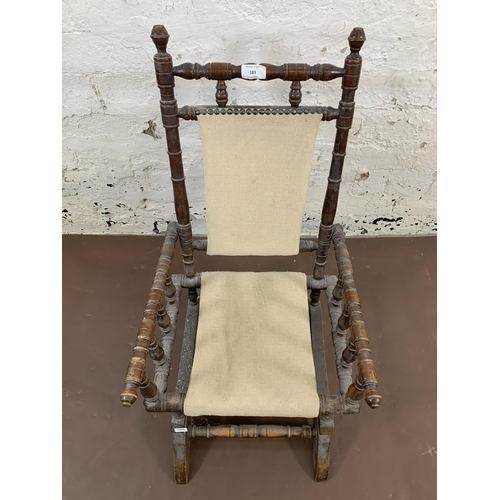 183 - An early 20th century American turned beech and fabric upholstered child's rocking chair - approx. 7... 