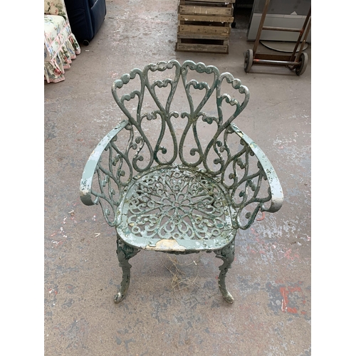 186 - Four pieces of green painted cast metal garden furniture, three chairs and one bench