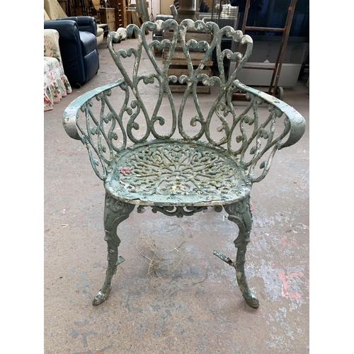 186 - Four pieces of green painted cast metal garden furniture, three chairs and one bench