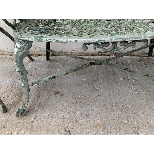 186 - Four pieces of green painted cast metal garden furniture, three chairs and one bench