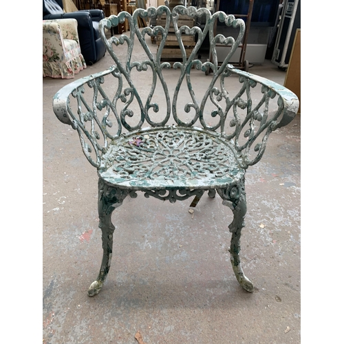 186 - Four pieces of green painted cast metal garden furniture, three chairs and one bench