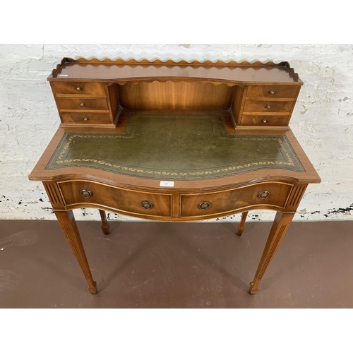 187 - A Burton Reproductions Limited mahogany and green leather writing desk on tapering supports - approx... 