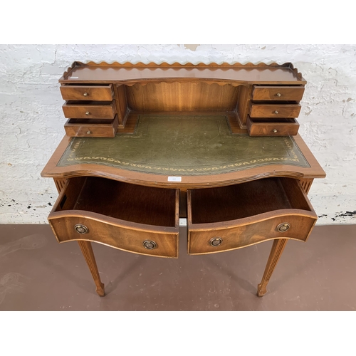 187 - A Burton Reproductions Limited mahogany and green leather writing desk on tapering supports - approx... 