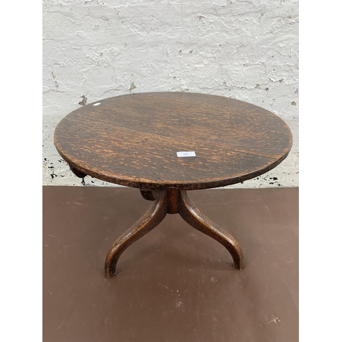 192 - A Georgian oak circular tripod occasional table - approx. 46cm high x 60cm diameter