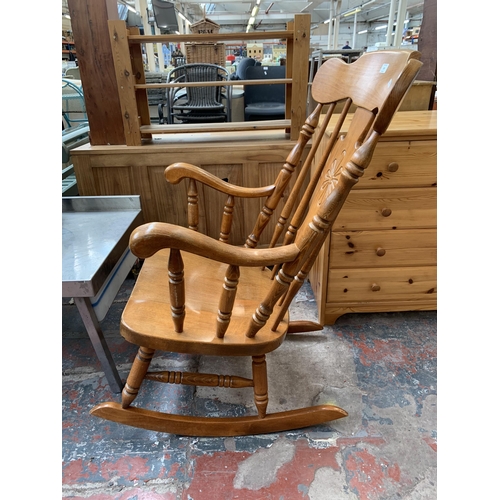 195 - A Victorian style beech rocking chair