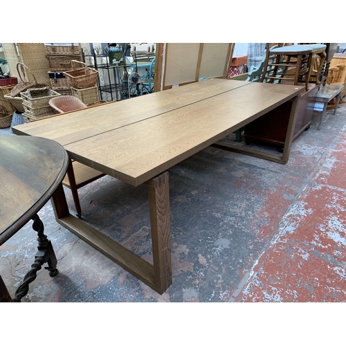 199 - A modern oak rectangular dining table - approx. 74cm high x 101cm wide x 220cm long