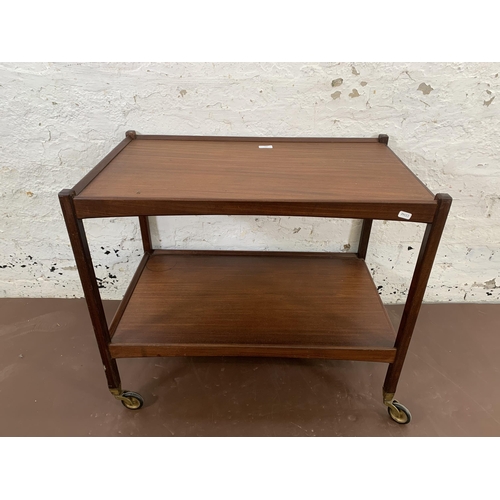 205 - A mid 20th century teak two tier drinks trolley - approx. 65cm high x 46cm wide x 76cm long