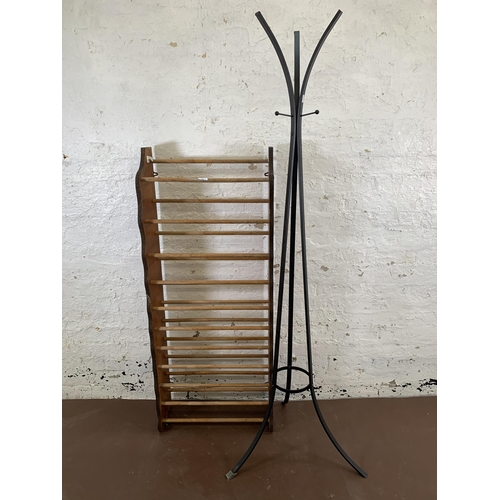 209 - Two pieces of furniture, one black metal coat rack and one plywood shoe rack