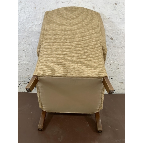 214 - A mid/late 20th century fabric upholstered and beech wingback armchair