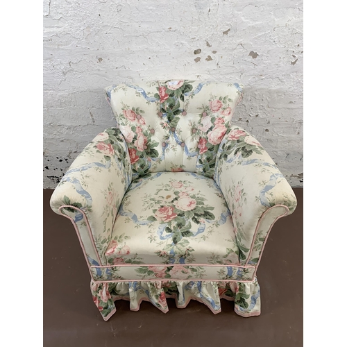 215 - An early 20th century floral fabric upholstered armchair