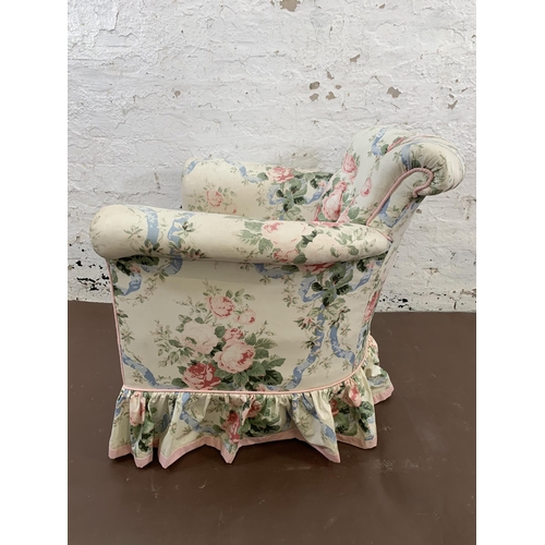 215 - An early 20th century floral fabric upholstered armchair