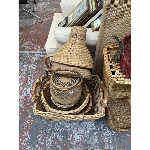 217 - A large collection of wicker furniture to include baskets, three section folding dressing screen, ma... 