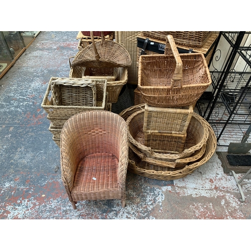 217 - A large collection of wicker furniture to include baskets, three section folding dressing screen, ma... 