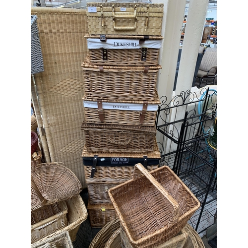 217 - A large collection of wicker furniture to include baskets, three section folding dressing screen, ma... 