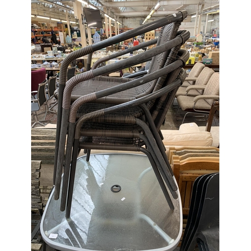 221 - A grey metal and glass patio table and four metal and wicker effect garden chairs