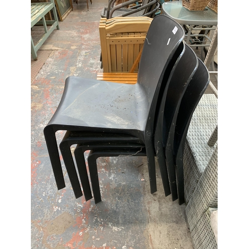 224 - Nine dining chairs, four black stacking and five beech folding