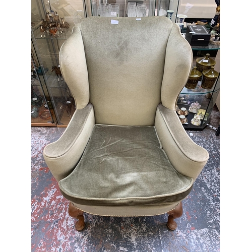 243 - A Georgian style green fabric upholstered wingback armchair on cabriole supports - approx. 98cm high... 