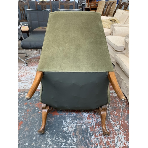 243 - A Georgian style green fabric upholstered wingback armchair on cabriole supports - approx. 98cm high... 