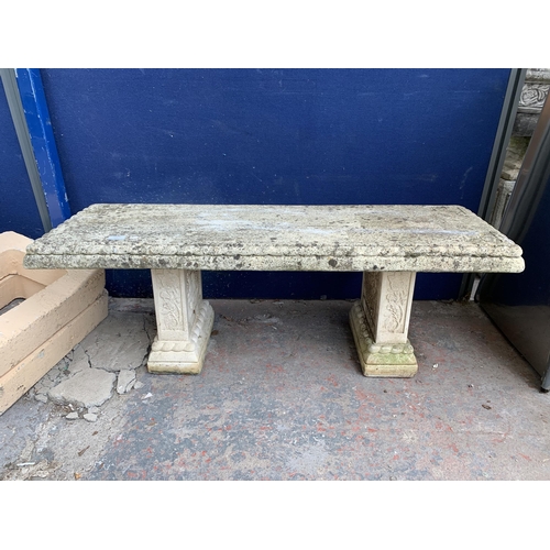 251 - A cast stone pedestal garden bench - approx. 42cm high x 114cm wide x 38cm deep