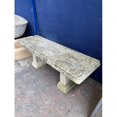 251 - A cast stone pedestal garden bench - approx. 42cm high x 114cm wide x 38cm deep