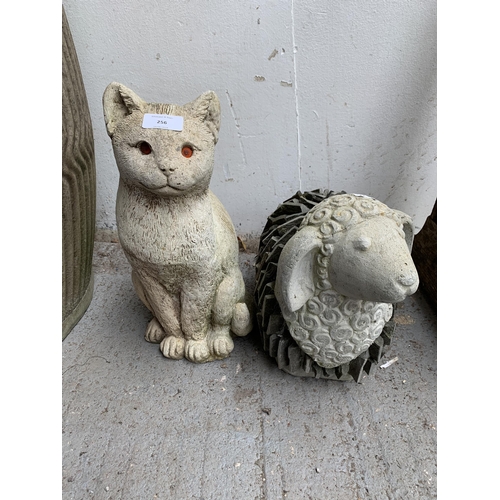 256 - Two cast stone garden figurines, one cat and one sheep