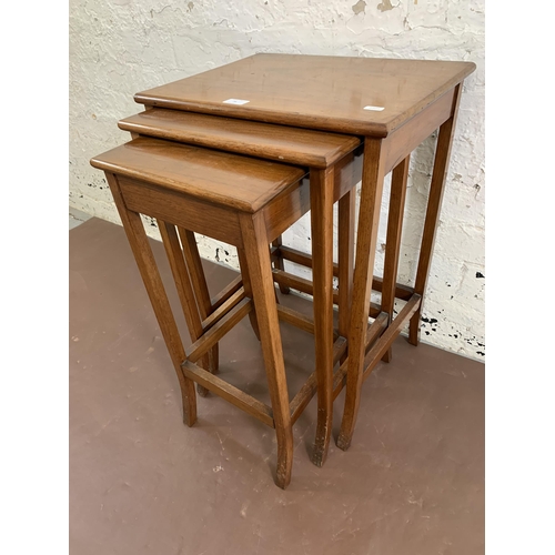 38 - An Edwardian style walnut nest of tables - largest approx. 68cm high x 46cm wide x 35cm deep