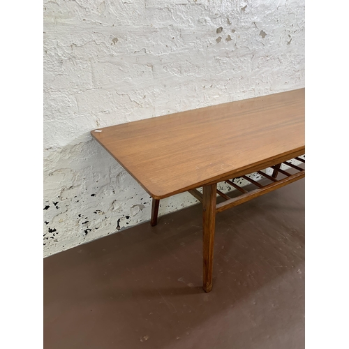 41 - A mid 20th century teak rectangular coffee table with lower magazine rack - approx. 49cm high x 50cm... 