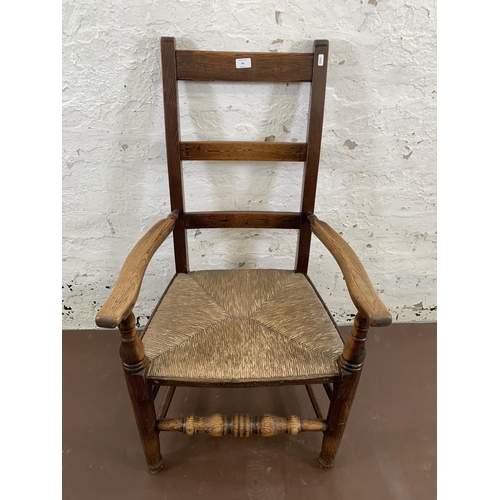44 - A 19th century style elm and rush seated ladderback farmhouse armchair