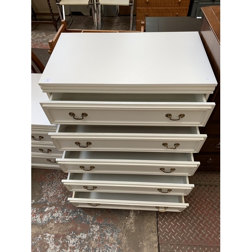 60 - A white laminate chest of drawers - approx. 98cm high x 81cm wide x 46cm deep