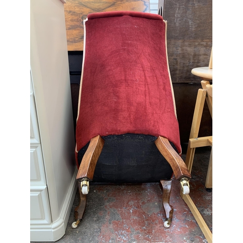 63 - A Victorian style beech and red fabric upholstered bedroom chair on brass and ceramic castors