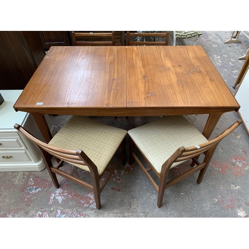 74 - A mid 20th century Younger teak extending dining table and four teak and fabric upholstered dining c... 