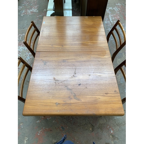 74 - A mid 20th century Younger teak extending dining table and four teak and fabric upholstered dining c... 