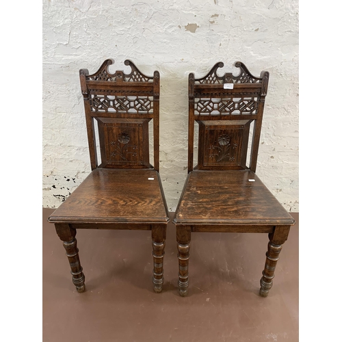 8 - A pair of 19th century carved oak hall chairs - approx. 90cm high x 44cm wide x 39cm deep