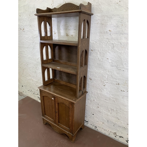 84 - An Arts & Crafts style oak bookcase - approx. 161cm high x 60cm wide x 28cm deep