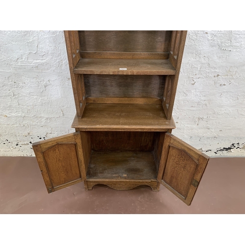 84 - An Arts & Crafts style oak bookcase - approx. 161cm high x 60cm wide x 28cm deep
