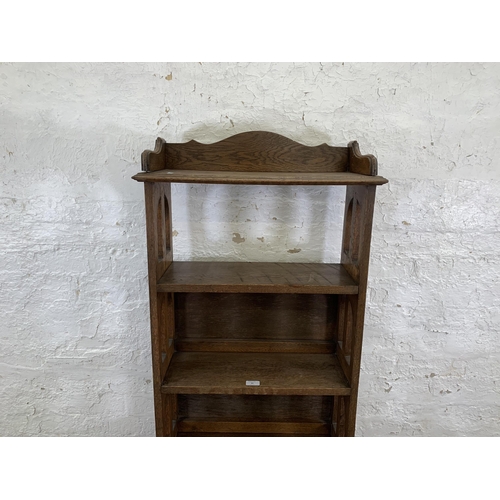 84 - An Arts & Crafts style oak bookcase - approx. 161cm high x 60cm wide x 28cm deep