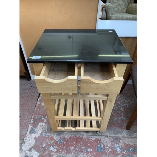 88 - A modern beech and black marble top kitchen trolley - approx. 75cm high x 49cm wide x 40cm deep