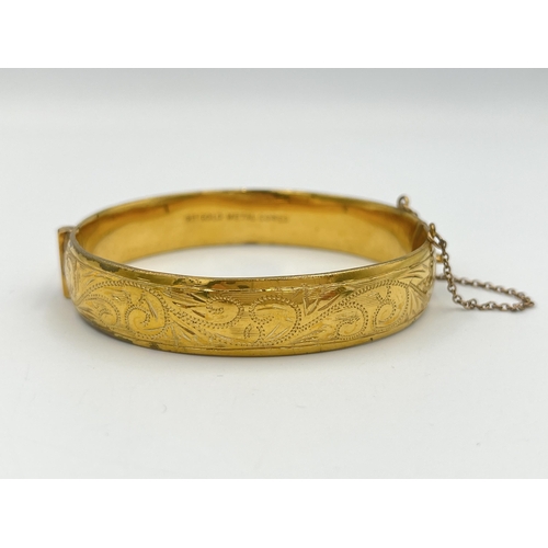 2285 - A 9ct gold metal core foliate etched bangle - approx. gross weight 19.9g