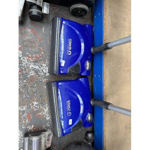 853 - Two Gtech cordless electronic sweepers with one charger