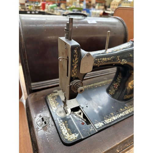 865 - A cased early 20th century Bradbury & Company Limited hand-crank sewing machine (serial number 18953... 