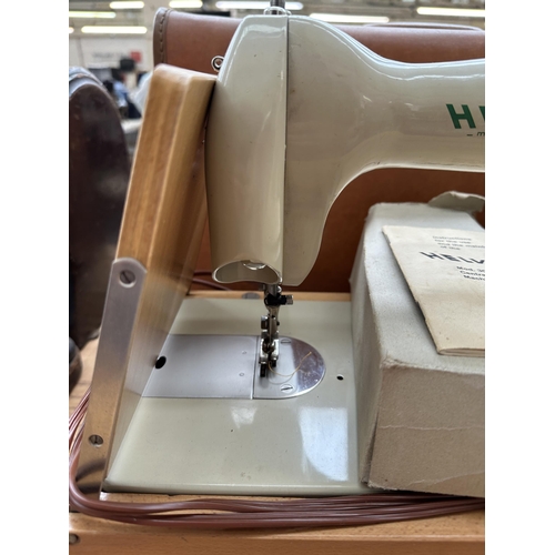 866 - A cased 1960s Helvetia 30-4 electric sewing machine with boxed foot pedal, accessories and instructi... 