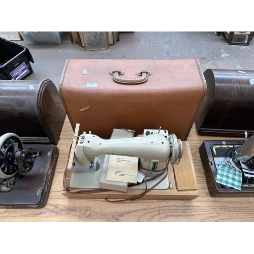 866 - A cased 1960s Helvetia 30-4 electric sewing machine with boxed foot pedal, accessories and instructi... 