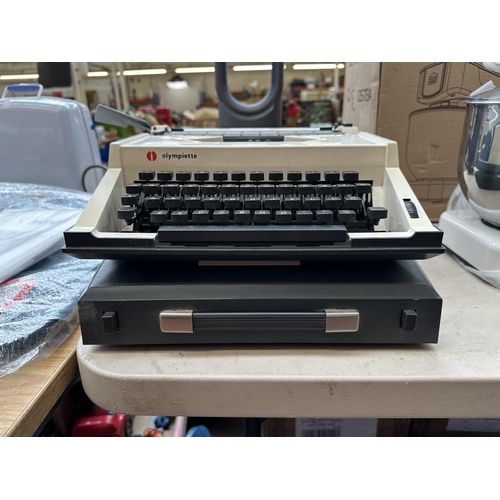 875 - A cased Olympia Olympiette portable typewriter