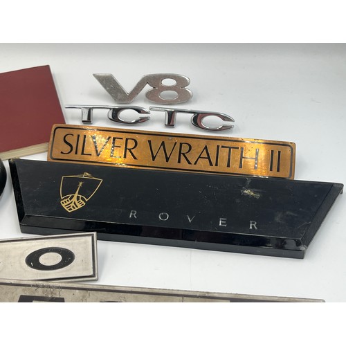 2301 - A collection of automobilia to include Rolls-Royce Silver Wraith II car badge, 3500 Rover S car badg... 