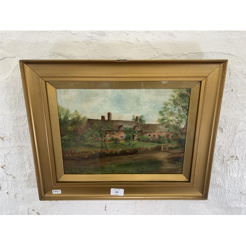 280 - An early 20th century gilt framed oil painting of a cottage scene, signed lower right ES - approx. 3... 