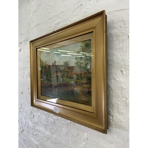 280 - An early 20th century gilt framed oil painting of a cottage scene, signed lower right ES - approx. 3... 