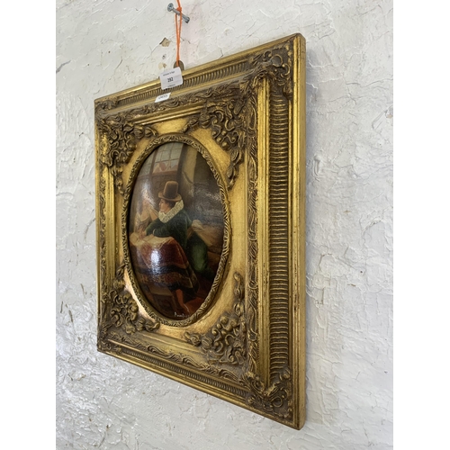 282 - A gilt framed oil on board of a couple signed lower right - approx. 41cm high x 36cm wide