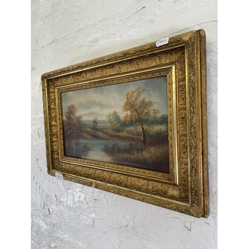 305 - A late 19th/early 20 century gilt framed oil on board of a  landscape scene - approx. 33cm high x 48... 