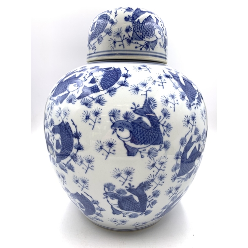 321 - A Chinese blue and white porcelain ginger jar and cover with Koi carp decoration - approx. 29cm high