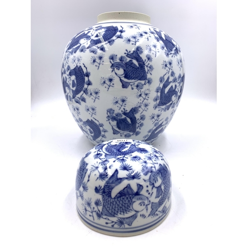 321 - A Chinese blue and white porcelain ginger jar and cover with Koi carp decoration - approx. 29cm high